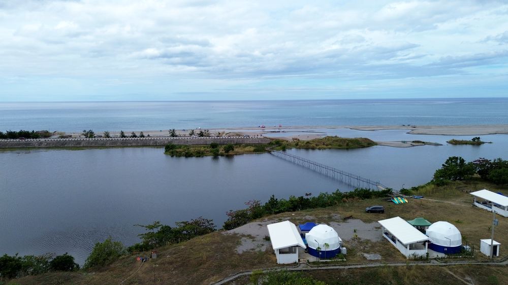 Aerial of the beach and sea beyond the AmanDagat lagoon