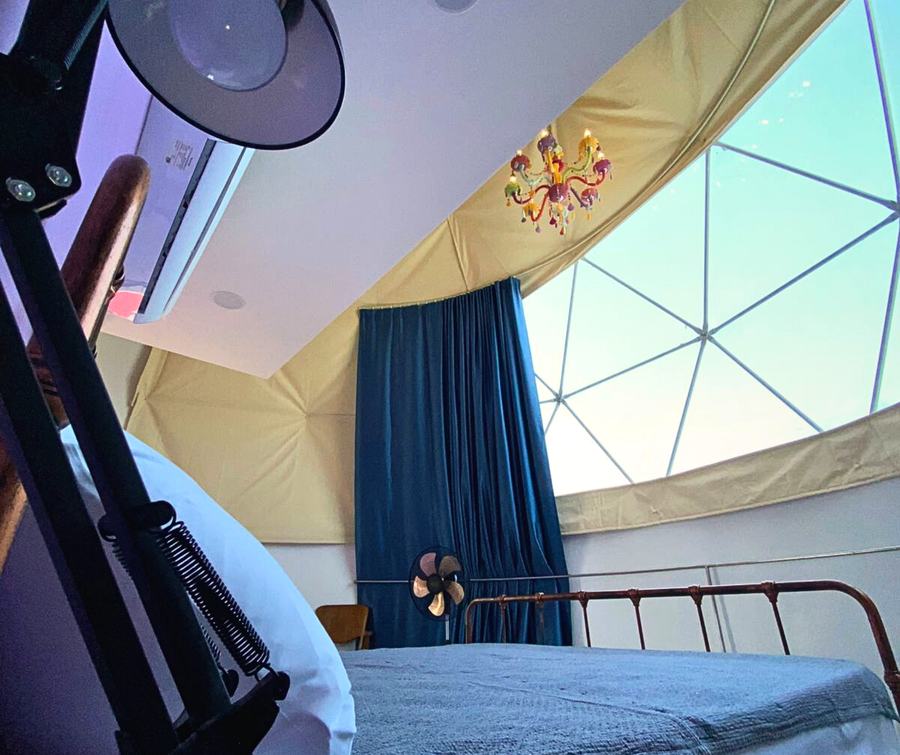 Dome Pearl Villa window with chandelier and dusk sky