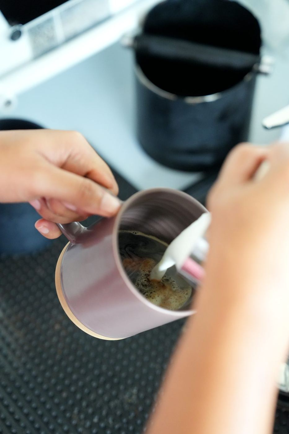 A barista pouring coffee at A’Züla