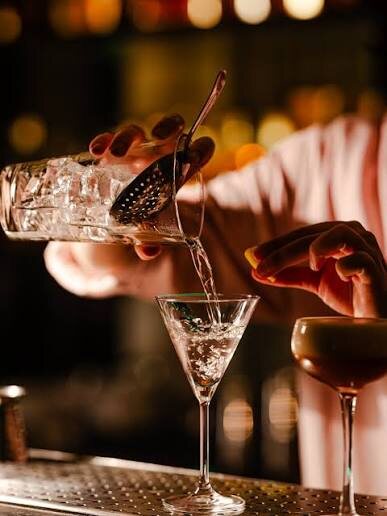 A cocktail strained into a glass at the A’Züla bar after dark