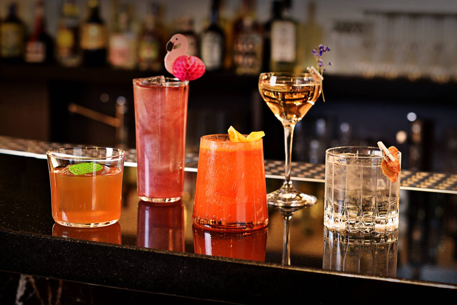 Five cocktails lined up on the A’Züla bar