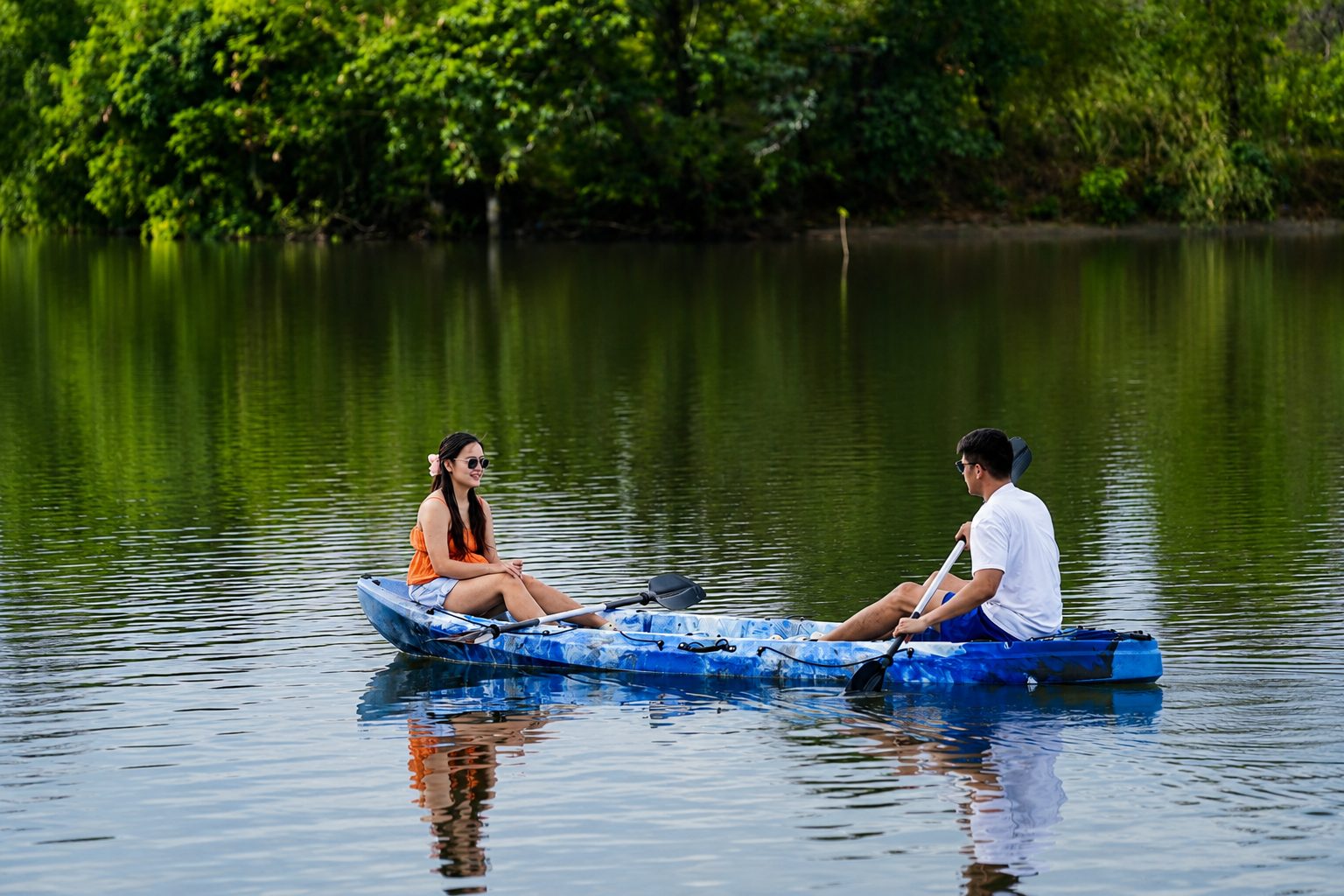 A couple kayaking the calm river