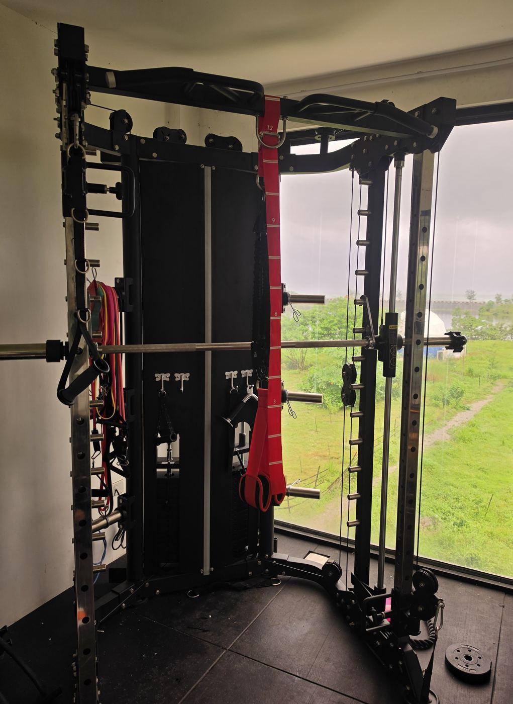 Functional trainer and squat rack in the gym overlooking the grounds at AmanDagat Beach Resort