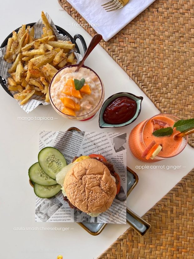 A’Züla smash cheeseburger with twister fries, mango tapioca, and fresh juice
