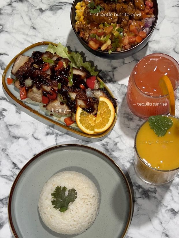 Crispy pork belly, chipotle burrito bowl, and tequila sunrise at A’Züla