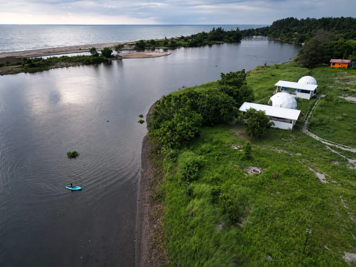Aerial of AmanDagat — the river, the domes, the beach and the sea beyond