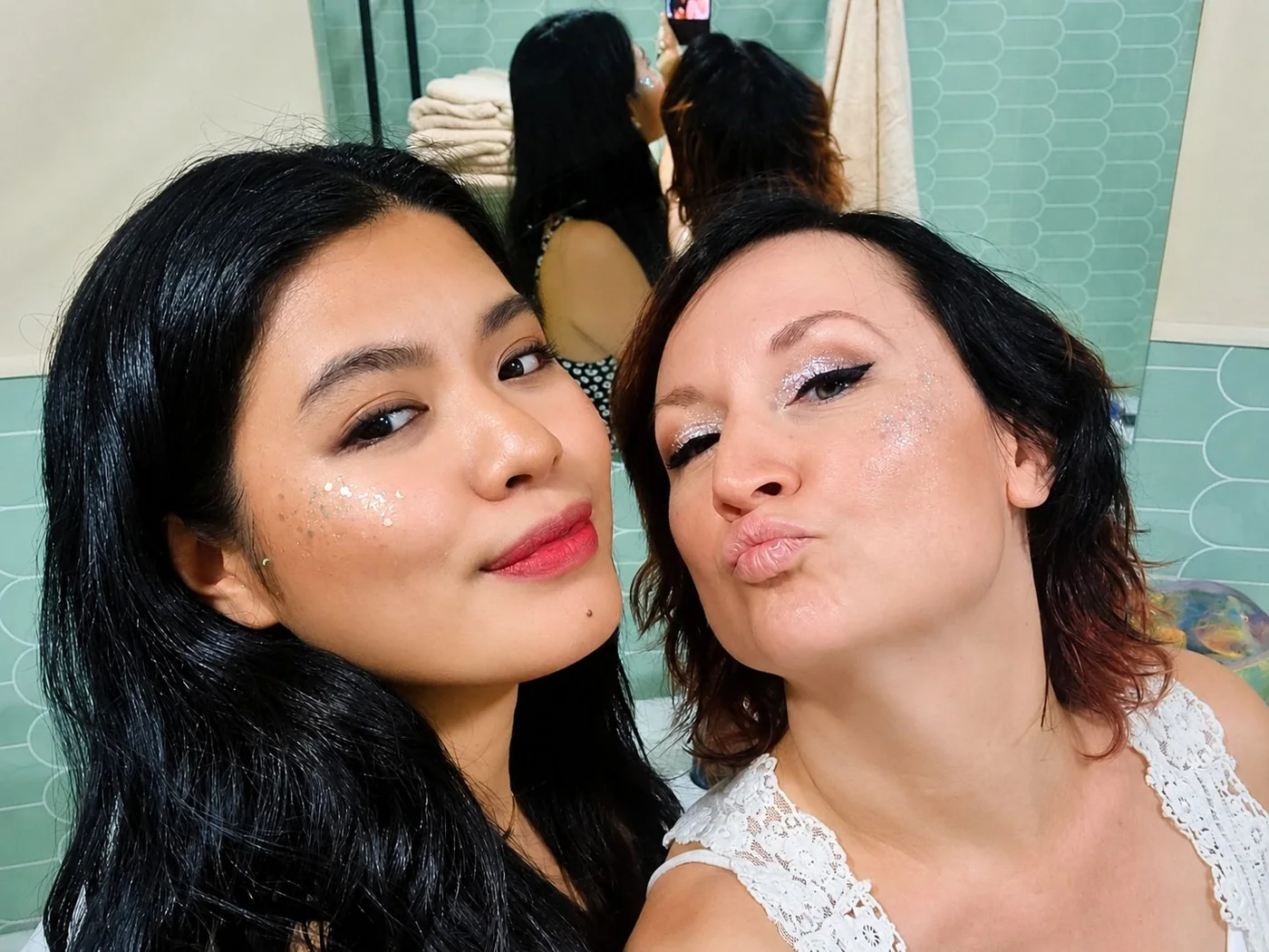 Two friends with glitter make-up getting ready