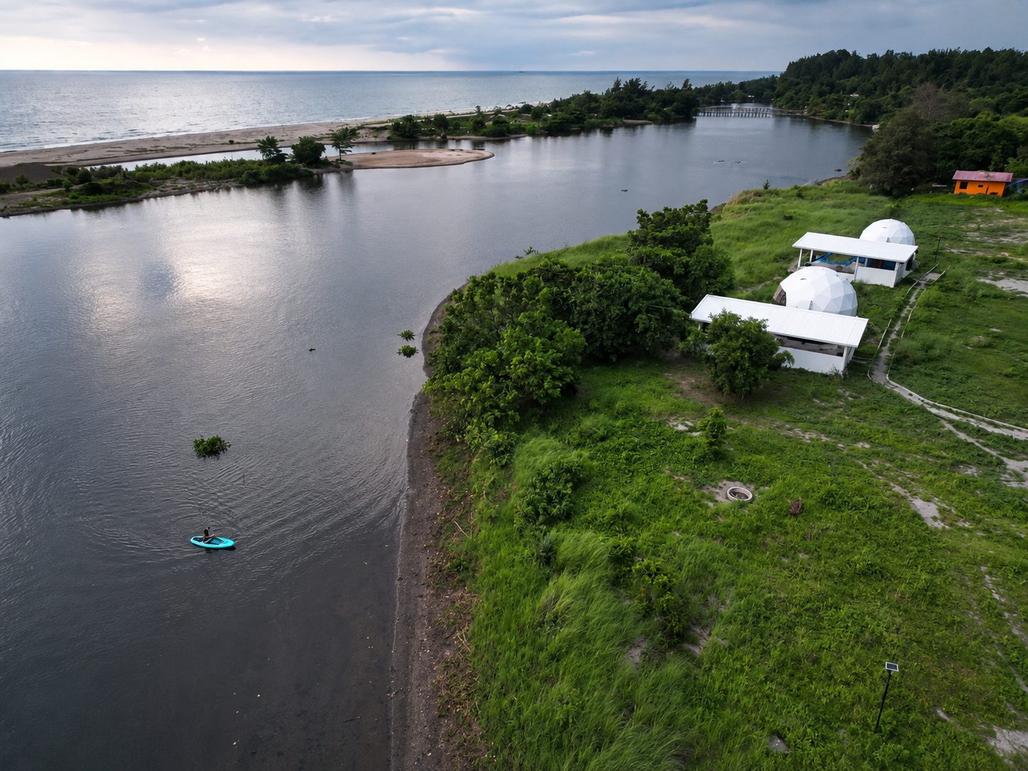Aerial of AmanDagat — the river, the domes, the beach and the sea beyond