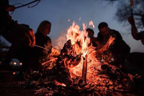 Guests sharing a beach bonfire at night in Zambales