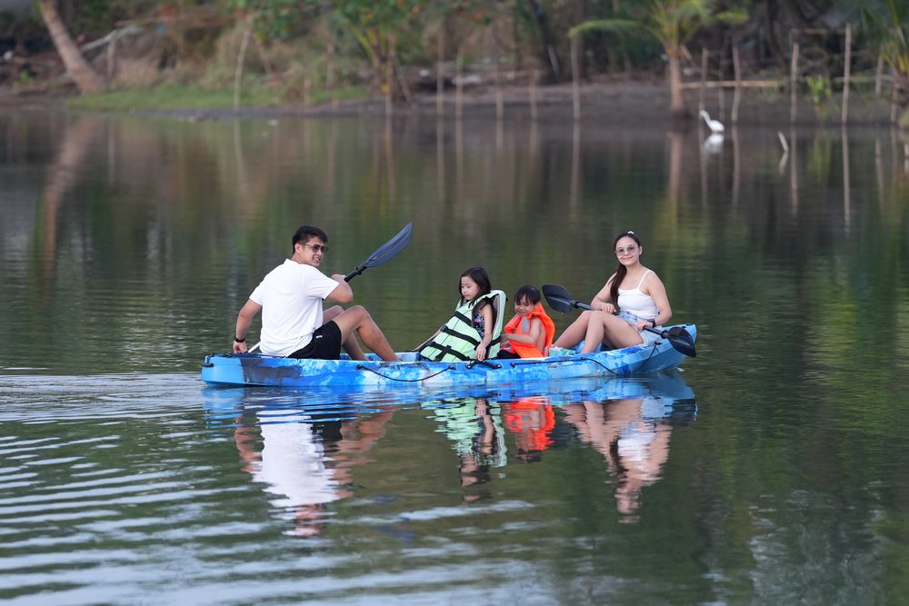 A couple kayaking on the calm lagoon at AmanDagat